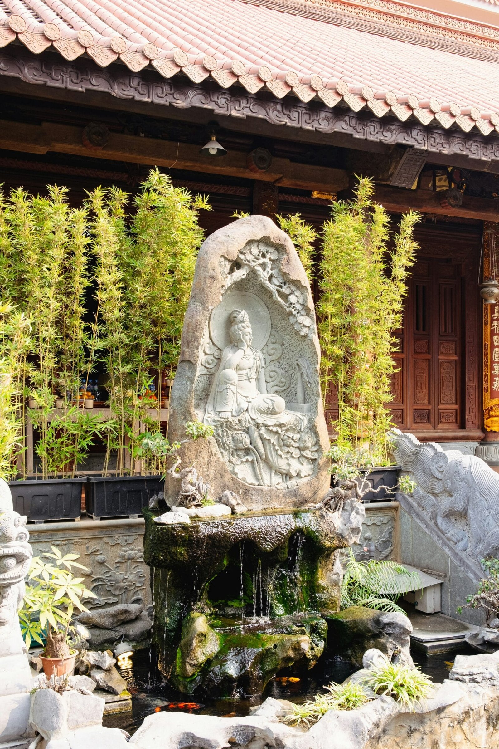 A garden with a fountain and a statue